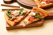 © Pixel-Shot - Slices of tasty pizza with Burrata cheese on yellow background