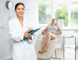 © JackF - Young woman cosmetologist in uniform makes notes in medical room