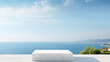 White marble square podium with sea view on a sunny summer day in the background. High quality photo