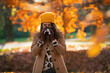 © Alliance - elegant woman in beige coat and orange hat