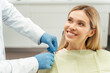© Maria Vitkovska - Portrait of smiling beautiful female patient with blond hair sitting in dental chair. Dental care