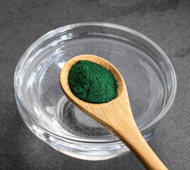 Wall Mural - Spoon with spirulina algae powder to mix with water