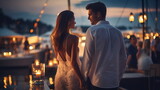 Fototapeta  - romantic couple in white clothers walk in harbor promenade,colorful blurred light of boat and city on sea water on horizon ,people relax on summer evening , 