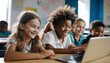 © ibreakstock - Smiling children with laptop in multiracial classroom