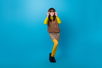 Canvas Print - Full length photo of positive good mood lady wear brown vest arms hands spectacles isolated blue color background