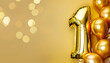 © Uuganbayar - Banner with number 1 golden balloons with copy space. One years anniversary celebration concept on a yellow background with shiny bokeh.