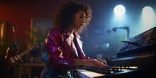 Young Woman Playing Keyboard In A Studio With Purple Lights