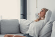 © Daniel - Young calm woman chilling relaxing leaning on comfortable sofa napping on couch in living room resting having healthy quiet nap, breathing fresh air, no stress free weekend at home, peace of mind.