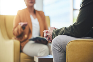 Wall Mural - Man, hands and listening for therapy, sofa or advice from woman for mental health, psychology or care. Psychiatrist, patient and frustrated in clinic, session or couch for help, anxiety or depression