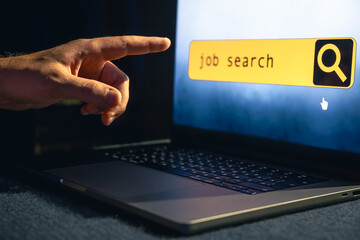 Wall Mural - man working on laptop and information for the searching job, employment concept.