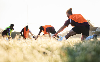 Canvas Print - Rugby, team and group stretching at training for match or competition in the morning doing warm up exercise on grass. Wellness, teamwork and people or players workout together in professional sports