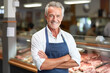 Happy middle-aged man, successful owner of a small business, owner of butcher shop, smiling at camera