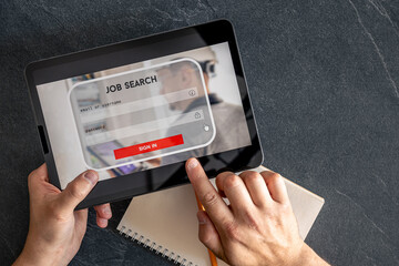Wall Mural - top view of digital tablet with search job on screen in male hands.