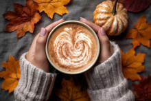 Top View Of Woman Hands Holding Coffee With Latte Art On Seasonal Autum Leaves Background