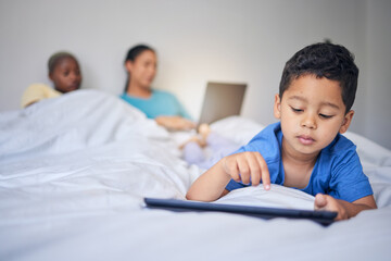 Poster - Children, tablet and education with a family in bed in the morning to relax together at home. Kids, technology and child development with a little boy in the bedroom to play a fun online game