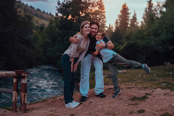 Sticker - Happy parents and their son posing by the mountain river at sunset