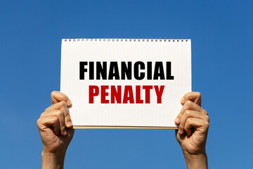 financial penalty text on notebook paper held by 2 hands with isolated blue sky background. this mes