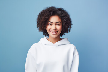 Wall Mural - Young woman wearing white sweatshirt mockup isolated on blue background. Generative AI.