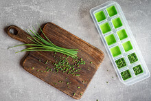 Green Fresh Organic Chives On Wooden Cutting Board Ready To Freeze. Overhead Shot.
