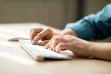 Aufkleber - Unrecognizable man typing on computer keyboard while sitting at desk