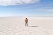 A man alone walking through the immensity of the salt flat. AI generated image.