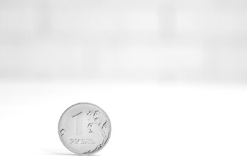 One Russian ruble coin on a light background