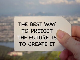Wall Mural - Motivational and inspirational wording. The Best Way To Predict The Future Is To Create It. Blurred styled background.
