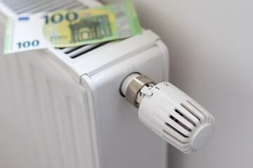 rising cost of heating and electricity in europe. heating radiator with thermostat on which euros li