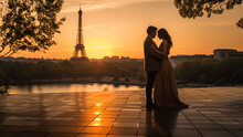 , A Couple Stands Close Together, Their Silhouettes Outlined Against The Backdrop Of The Iconic Eiffel Tower.