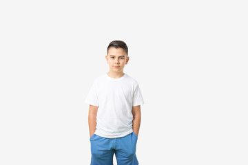 adorable young happy boy wearing white t-shirt and blue short