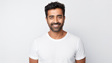 Portrait Of An Attractive Indian Male In His 30s With A Beard Smile And Looking Into The Camera Isolated Against A White Background