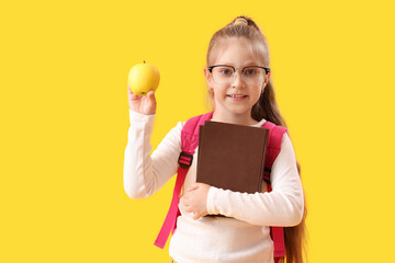 Sticker - Little schoolgirl with books and apple on yellow background