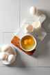 © The Picture Pantry - Egg with a double yolk cracked in a small bowl