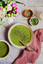 Flatlay Of A Bowl Of Green Vegetable Soup On A Tiled Surface With Flowers