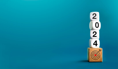 Poster - 2024 Happy New year background banner. Numbers on white dices on target icon on wooden cube blocks stacked on blue background with copy space. Welcome, Merry Christmas, and Happy New Year in 2024.