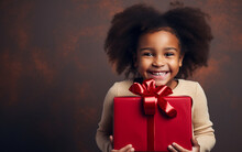 Black African American Dark-skinned Happy Little Smiling Girl With Christmas Gift Box At Home. Holidays And Celebration Concept
