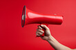 © Acres - A Red megaphone being held on a red background