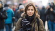 Portrait of professional female journalist at work. Young woman standing on the street holding camera and smiling