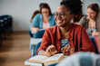 © Drazen - Happy black female student during class at university.