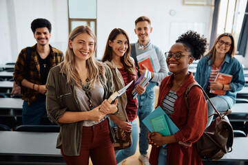 multiethnic group of university students in lecture hall looking at camera.