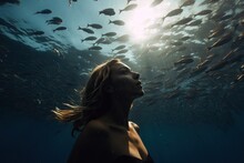 A Girl Swims Underwater With Fish