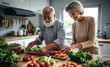 © visoot - Happy seniors prepare vegan food in modern kitchen at home.