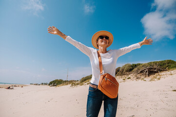 Beautiful woman enjoying nice weather on the beach, blue sky, clean sand in Playa de la Ballena Spain Europe