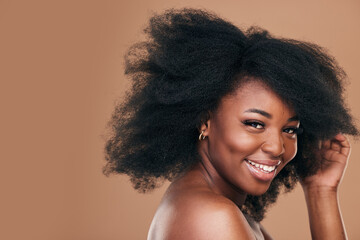 Wall Mural - Portrait, hair care and black woman with smile, beauty and wellness on a brown studio background. Mockup space, person and model with texture, afro and natural with aesthetic, makeup and cosmetics