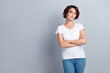 © deagreez - Photo of confident dreamy woman dressed white t-shirt arms crossed looking empty space isolated grey color background