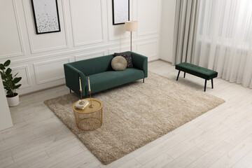 Poster - Stylish living room with soft beige carpet, coffee table and sofa, above view. Interior design