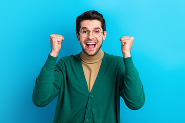 Poster - Portrait of overjoyed positive man raise fists accomplishment shout yes hooray isolated on blue color background