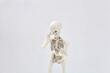 Human skeleton covers his face with his hand, shy and shame concept