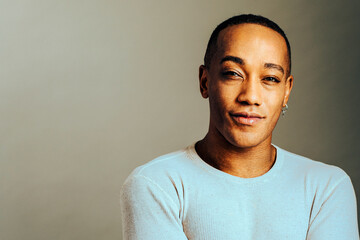 man with a charming smile looking at camera, headshot, studio shot