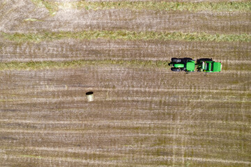 Wall Mural - Aerial view of tractor with hay bale. Portugal